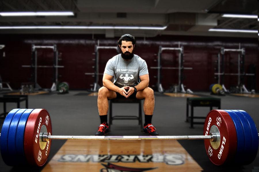 English teacher Christopher Farrell, S.J. pauses for a quiet moment before deadlifting 425 pounds. Farrell started a powerlifting club which meets every day after school.