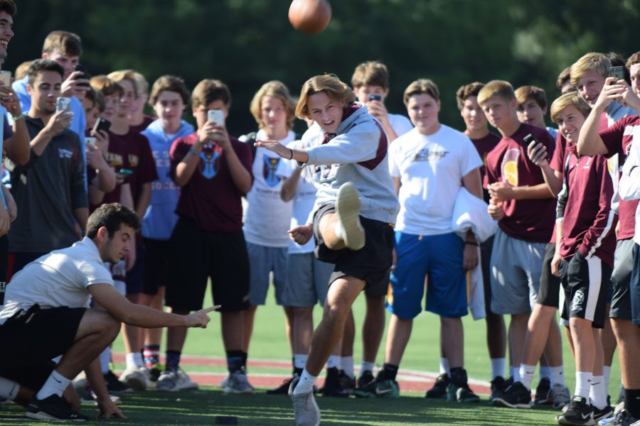 Senior Adam Weis boots the game winning kick in the field goal kicking contest Friday.