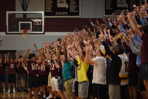 Students sit in the stands while cheering