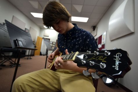 Sophomore Jeff Patterson plays his guitar in the band room after school