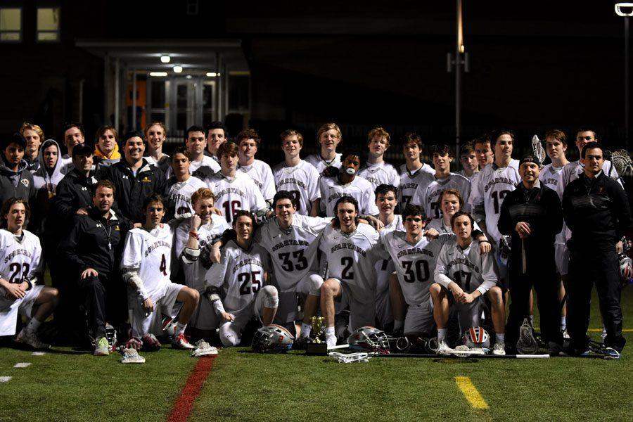 The varsity lacrosse team poses for a pictures after defeating the CBC Cadets to win the MCC Preseason Championship