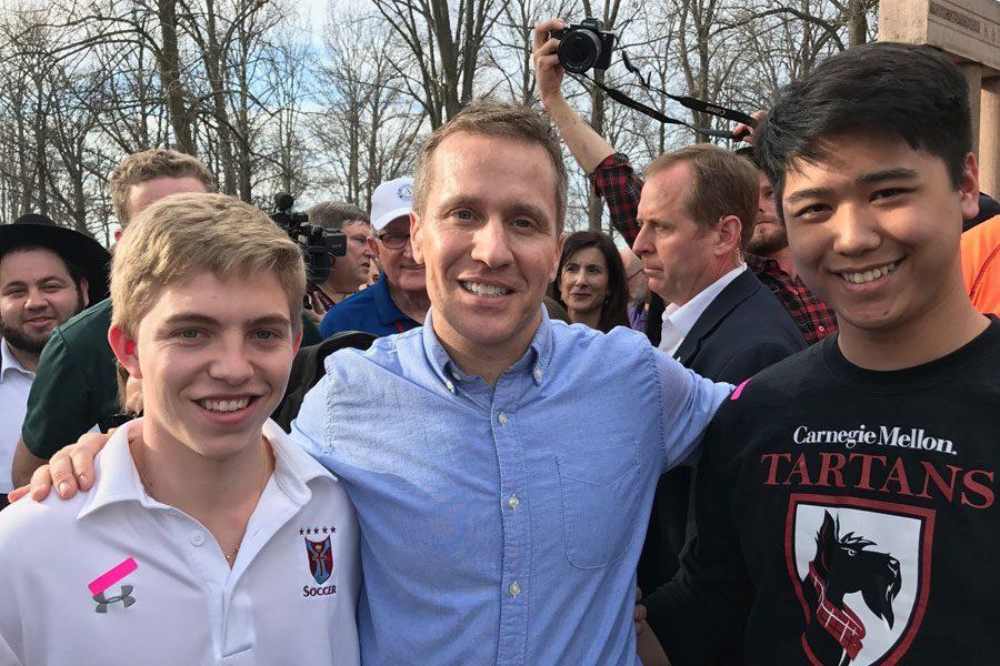 Seniors+Michael+Tran+and+Sam+Radetic+stop+for+a+picture+with+Governor+Eric+Greitens+while+volunteering+at+Chesed+Shel+Emeth+Cemetery.+