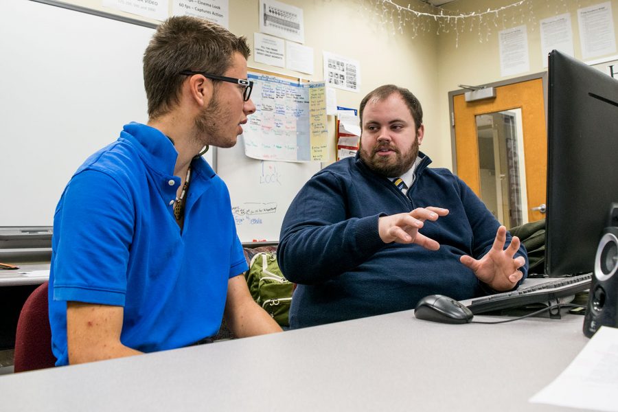 In an effort to improve his programming skills, senior Justin McNeil discusses the C# program with computer science teacher Ryan Sextro. McNeil is learning the computer language as part of his independent study program.