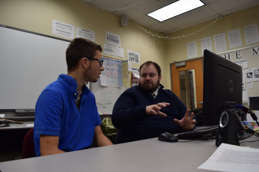 In an effort to improve his programming skills, senior Justin McNeil discusses the C# program with computer science teacher Ryan Sextro. McNeil is learning the computer language as part of his independent study program.