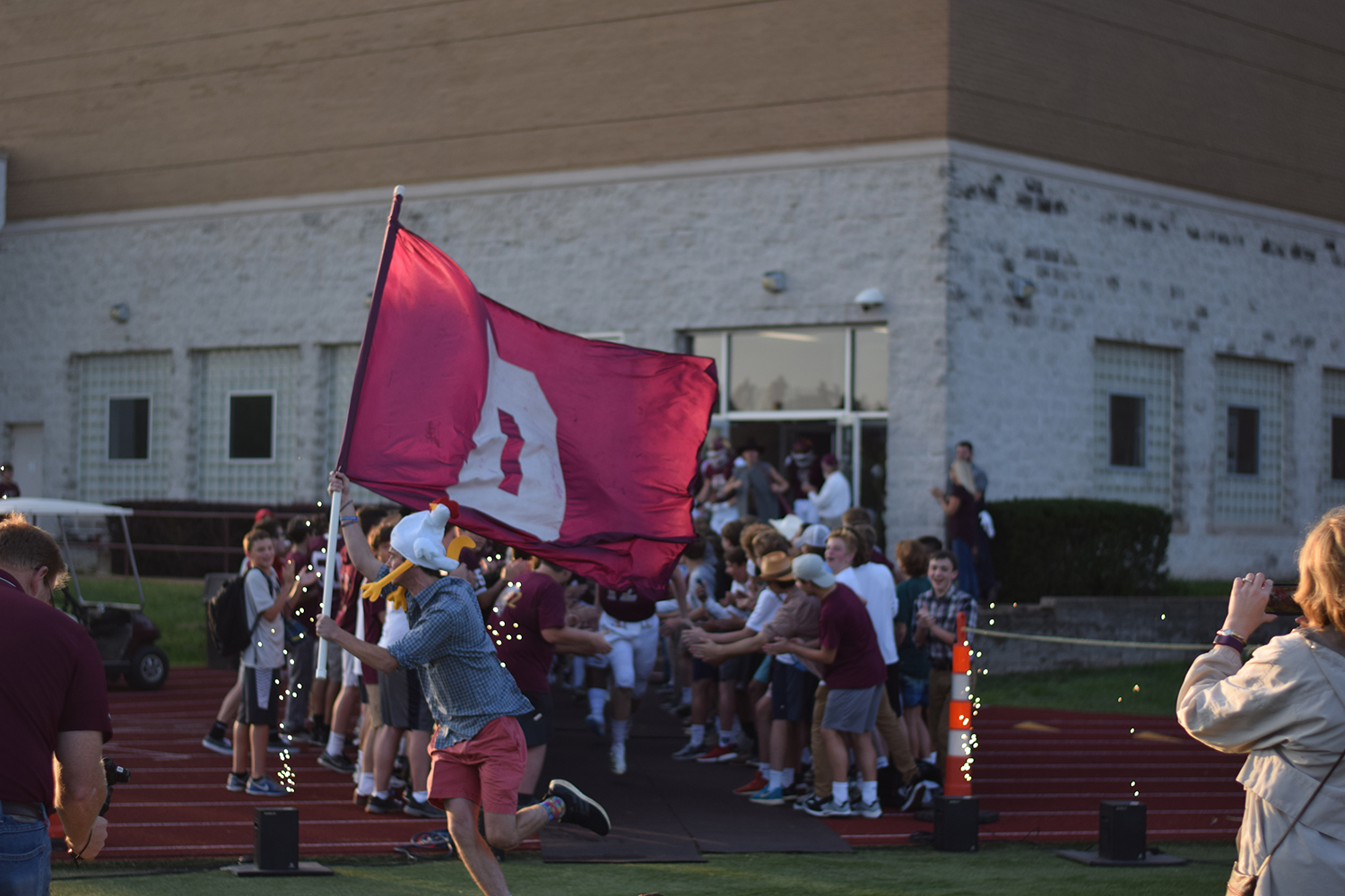 Senior Nick Einig, leads out the Varsity football team during the start of the Hazelwood Central game.