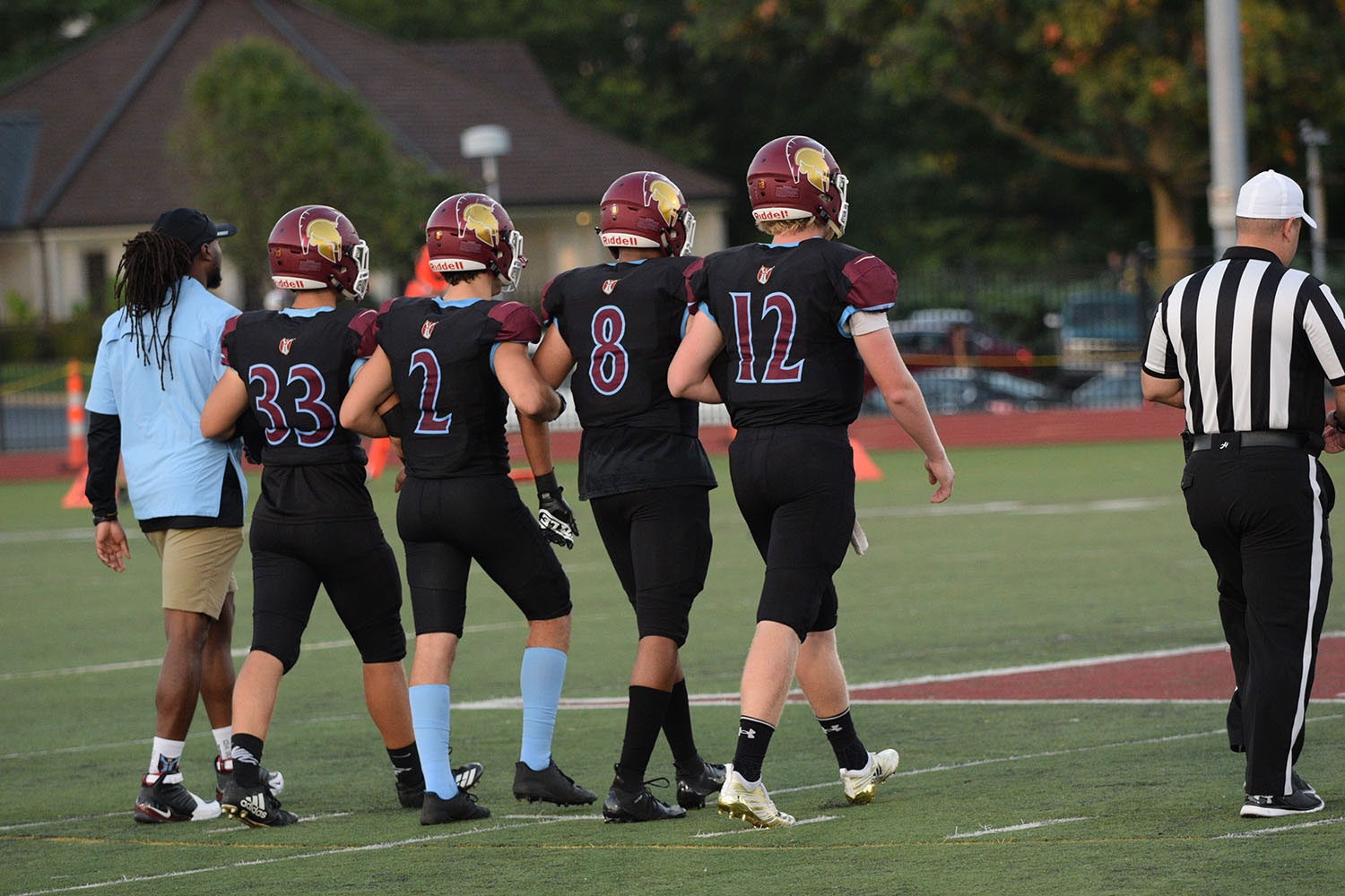 Senior captains Joe Jansen, Grant Stegman, Seth Harris, Nate Martens walk out to the coin toss with head coach Robert Steeples.
