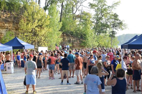 Swim Across America participants listen to personal stories from cancer survivors. The event raised over $200,000 for cancer research.