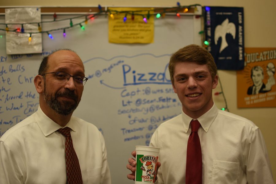 Senior Tyler Dawson and club moderator Ray Sherrock pose with a Fortel's Pizza cup.