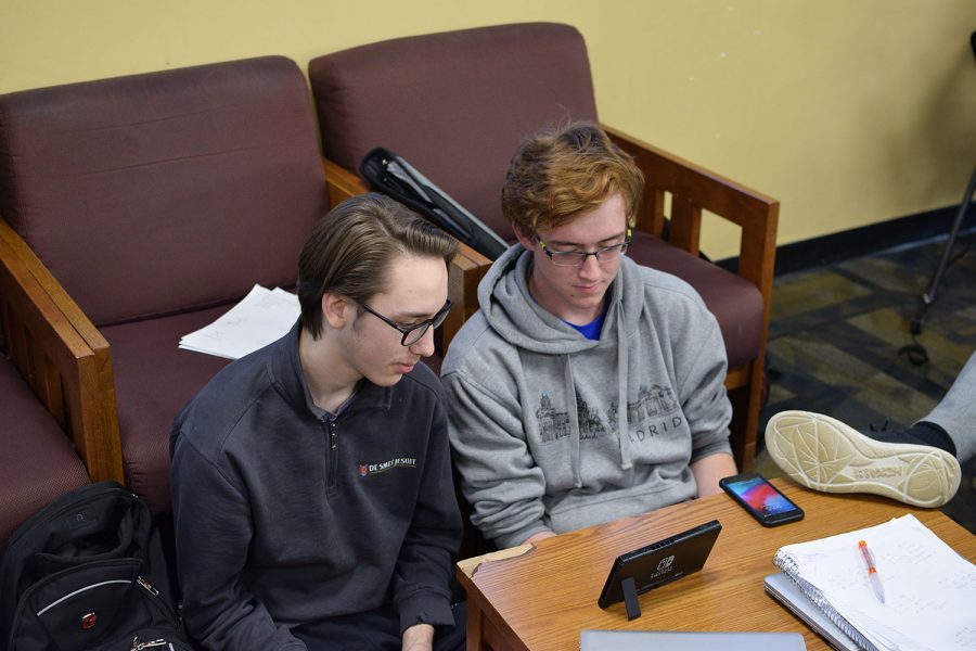 Taking a break from studying two students relax by playing the Nintendo Switch.