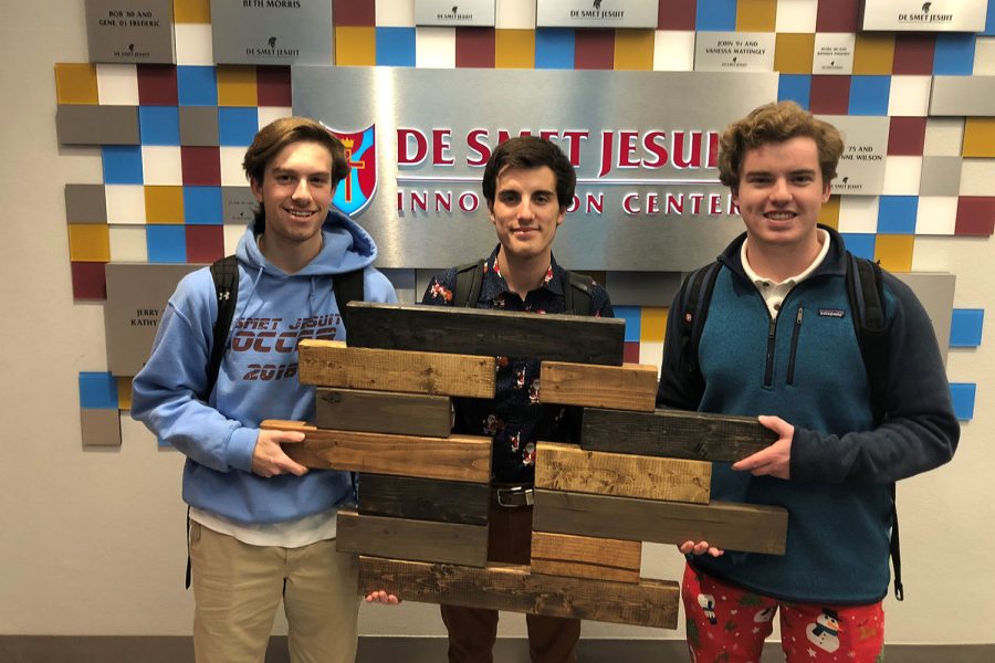 Ethan Heady, Thomas Hubeli, and Colin Doherty pose with their cross. The crosses are hand made and sold around $10-15 each. 