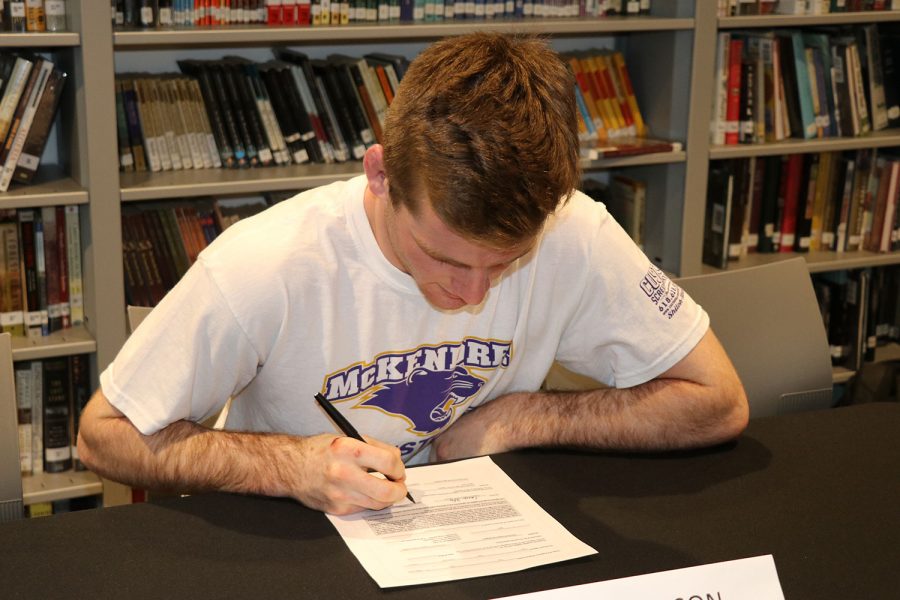 Cory Peterson signs a letter of intent to wrestle for McKendree University.
