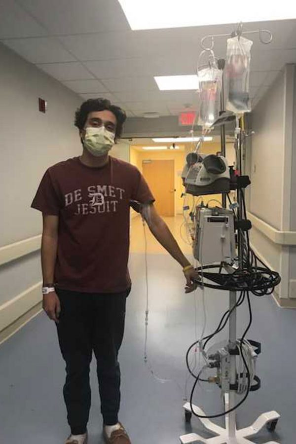 Jack walking down the hospital hallways while carrying his machine.