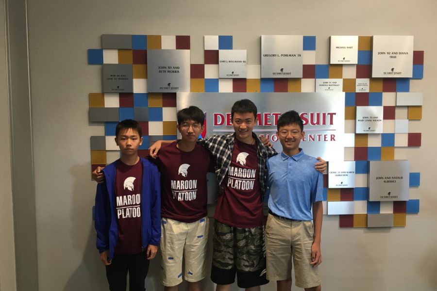 Vic, Allen, Eddie, and Tony take a photo in front of the De Smet Innovation Center