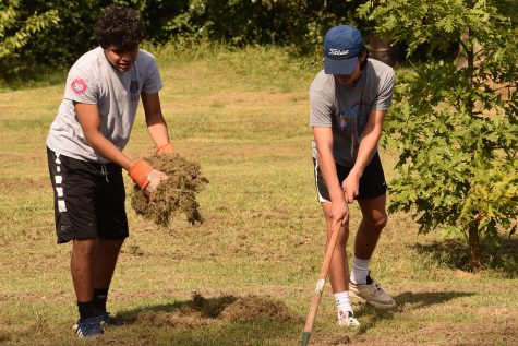 Juniors Peter Molitor and Dominic Genovese take part in their service project.