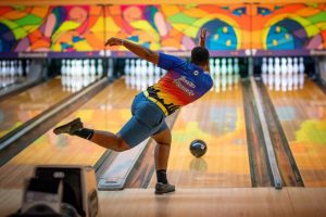 Senior Justin Kennedy bowls a strike during a bowling game.