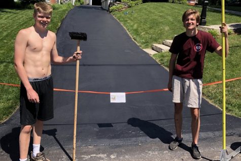 Seniors Michael Dolan and Jack Venneman pose for a photo after sealing their first driveway over the summer.