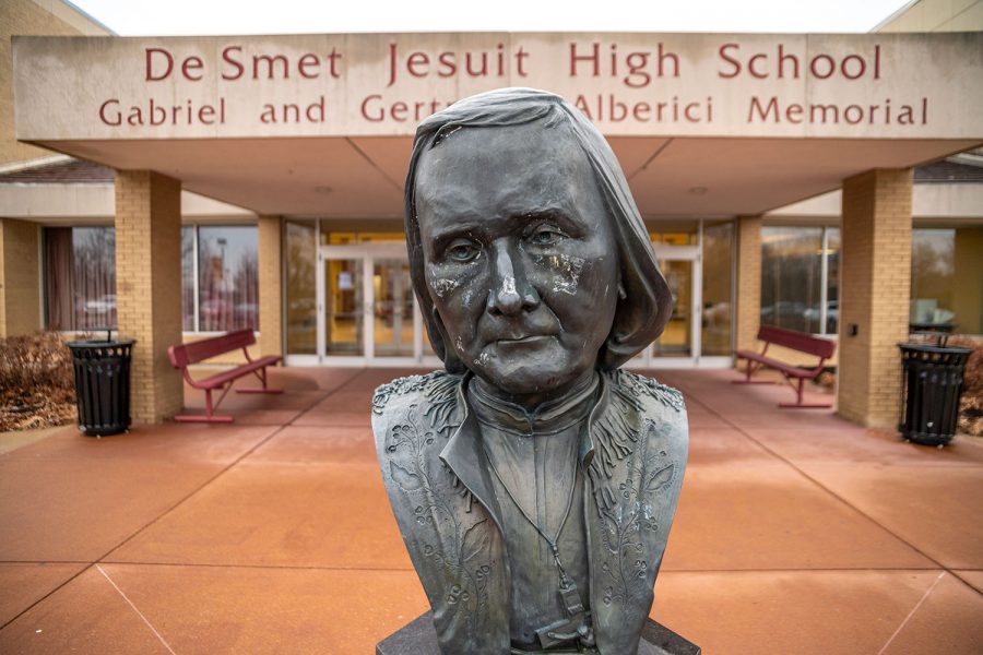 The statue of Fr. Peter De Smet greets students as they enter the school each day. Students will have eight days this year when school will start 40 minutes later to give leaders of clubs and activities time to plan various events.