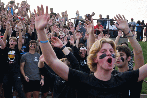 Colin Brunts leads the student section dressed in a black out theme ahead of the opening kickoff. 