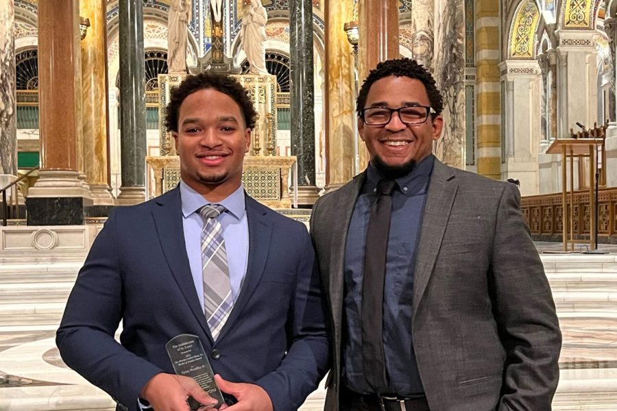 TJ Woodley 22 and Director of Diversity and Inclusion Dr. Dre Cox celebrate Woodley receiving the Dr. Martin Luther King Model of Justice Award Jan.  16, 2022 at the Cathedral Basilica of St. Louis.