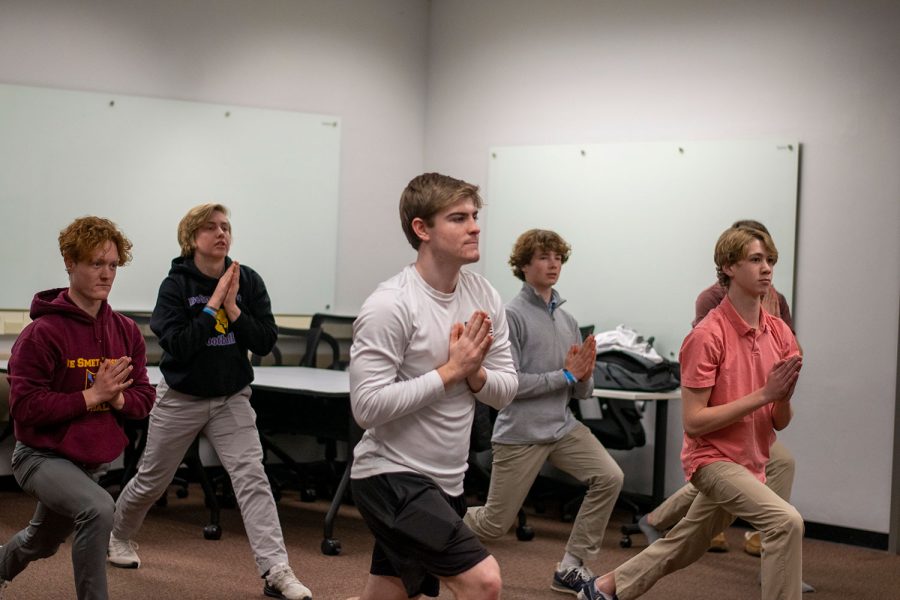 Bryce Patterson 22, Andrew Smith 24, Cole Grothoff 22, Carson Smith 24, and Nick Finlay 24 pose during Yoga Club  in the faculty collaborative space on March 11.