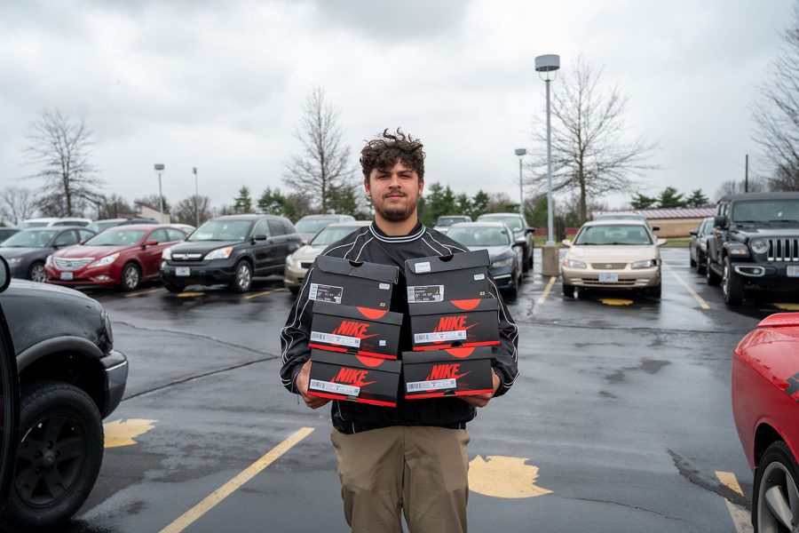 Giovanni Gino Kristo 22 poses with his Jordan 1s he plans to sells to his customers