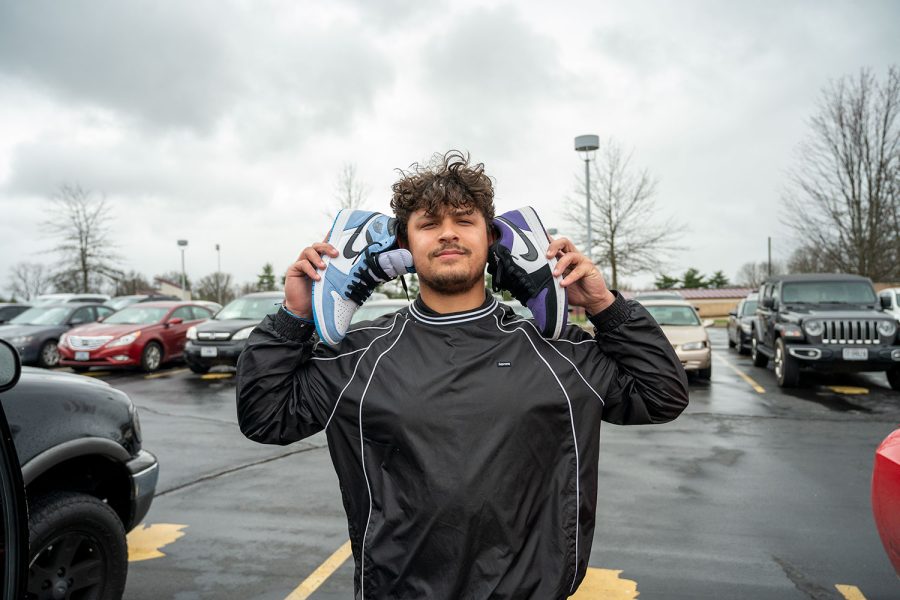 Giovanni Gino Kristo 22 poses with his Jordan 1s he plans to sells to his customers