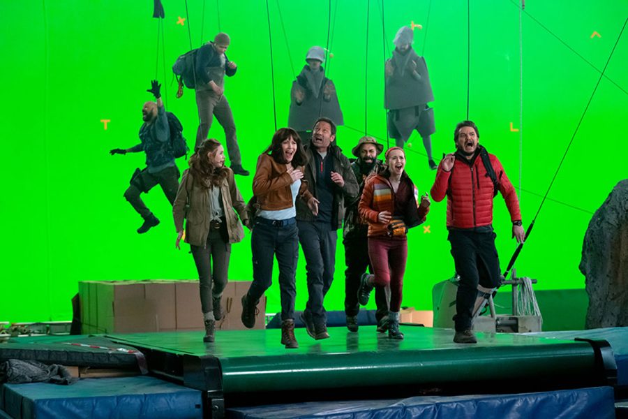 Karen Gillan, Iris Apatow, Fred Armisen, David Duchovny, Keegan-Michael Key, and Leslie Mann shoot a scene for their dinosaur action film while stuck inside a pandemic bubble in the new Netflix movie The Bubble.