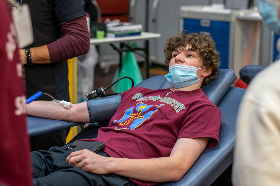 Cole Erusha 23 gives blood during the blood drive last school year. The goal is to collect 40 units of blood this year.