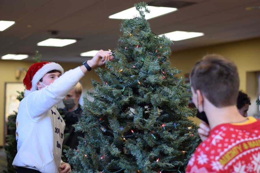 August Waller 22 sets up a Christmas tree for last years Christmas on Campus at De Smet Jesuit.