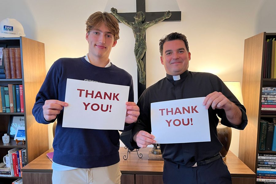 Tommy Ruder 23 and president Fr. Ronny ODwyer, S.J. give thanks for the success of giving Tuesday that raised over $700 thousand.