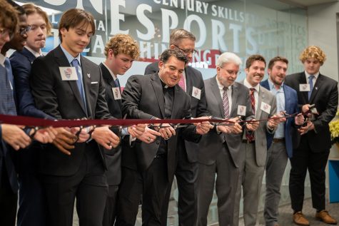President Ronny ODwyer S.J. leads the Blackrobe Society and members of the E-Sports team in officially dedicating the new facility Dec. 8.
