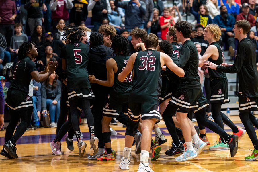 De Smet Basketball team mobs Ian Thomas 26 after sinking a game winning free throw in a MCC matchup against CBC