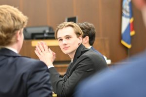 Hudson Miller '24 listens attentively to a teammate during a Mock Trial competition.