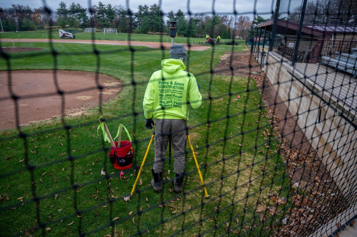 Wrokers survey the field as they prepare to remove 7 inches of dirt before installing new synthetic turf on the infield and bullpens.