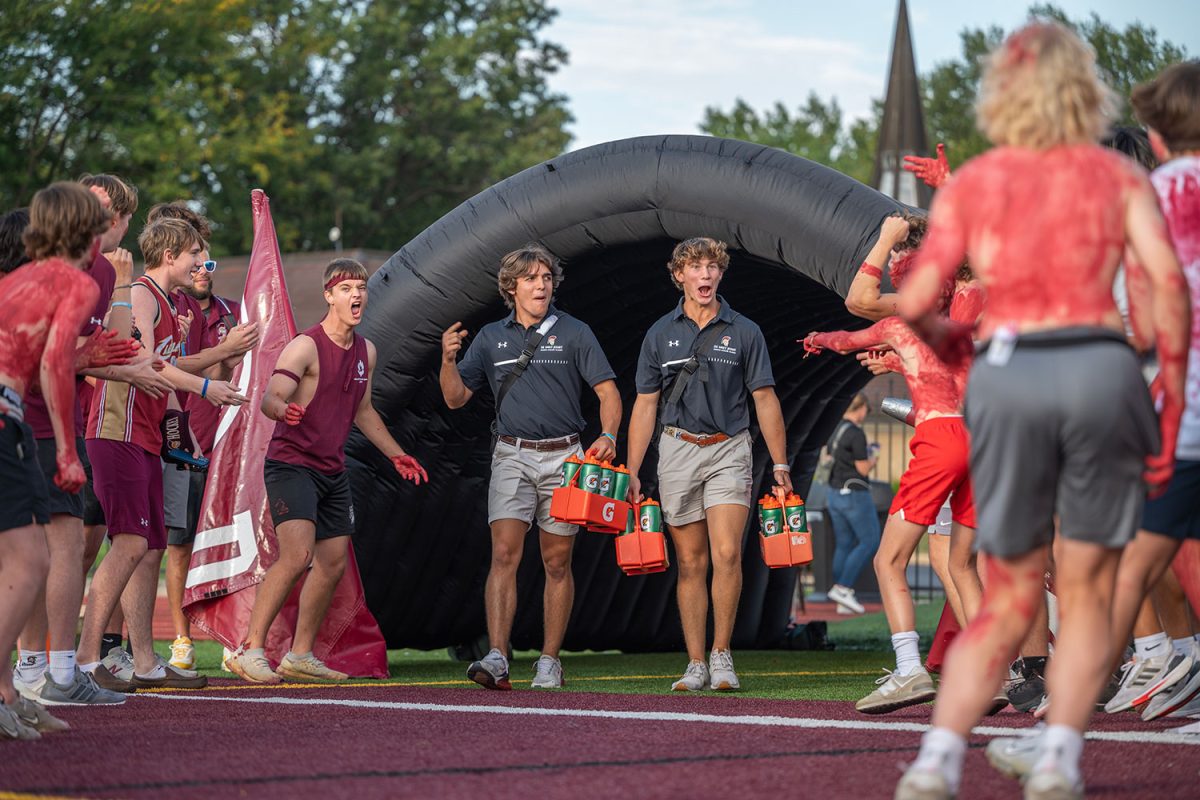 Jack Trout 25 and Michael Schmidt 25 walk out of the tunnel in the home opener football game against Chaminade on Sept. 8.