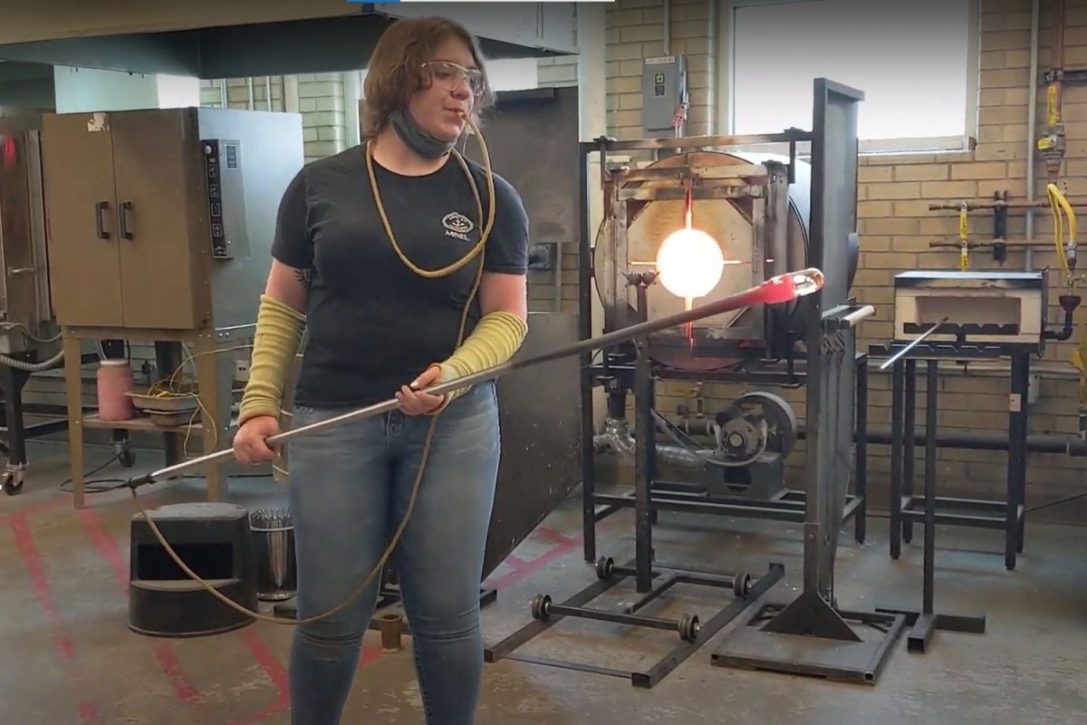 Emma Braun prepares to blow in a starter bubble for a glass project in Colorado.