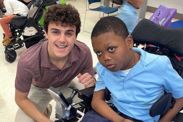 Junior Dominic Nicoletti and one of the students in his homeroom pose for a picture in the cafeteria before dismissing for the school day. 