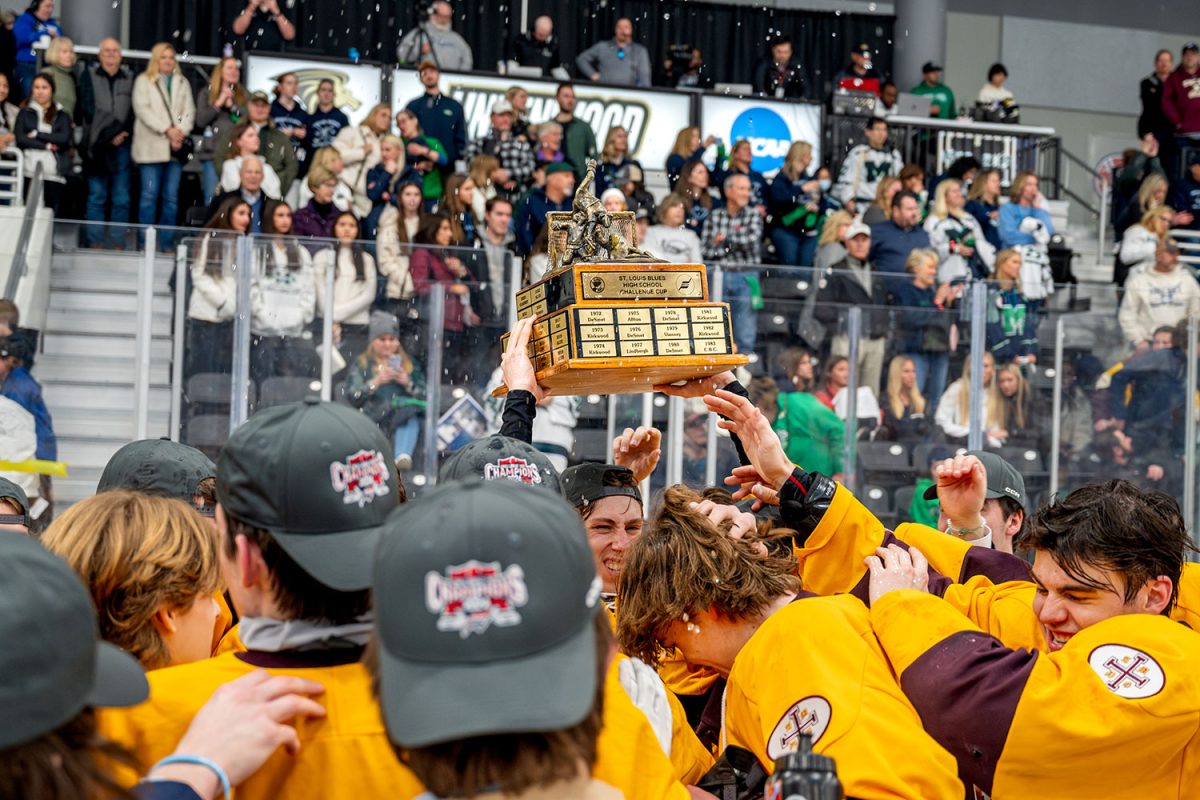 The team gets sprayed with water as they celebrate with the Challenge Cup trophy. They won the trophy for the second straight season.