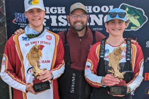 Danny Swallow 24, boat captain Jeff Geiser, and Nick Whitney 24 celebrate their 2024 TBF Student Angler Federation Missouri State Championship at Lake of the Ozarks March 16.
