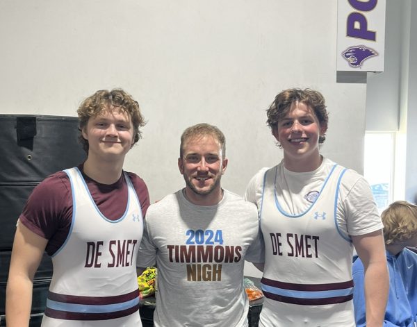 Will Timmons 24, Teacher Alexander Hall, and Myles Nigh 24 take a picture after the end of a powerlifting meet for De Smets new Powerlifting club.