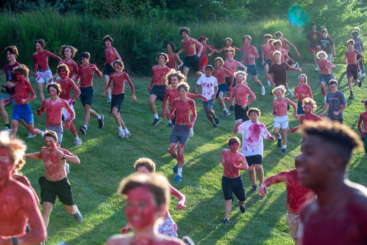 Students run on to the field during the running of the Spartans last year before the opening Friday night football game against Chaminade. The event will take place at the home opening soccer game this year.