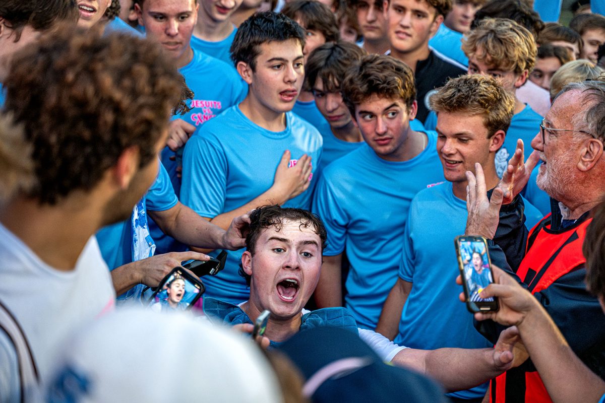 Nico Putman '25 gets his hair cut by SLUH students at halftime for cancer awareness on September 13th 2024 at SLUH.