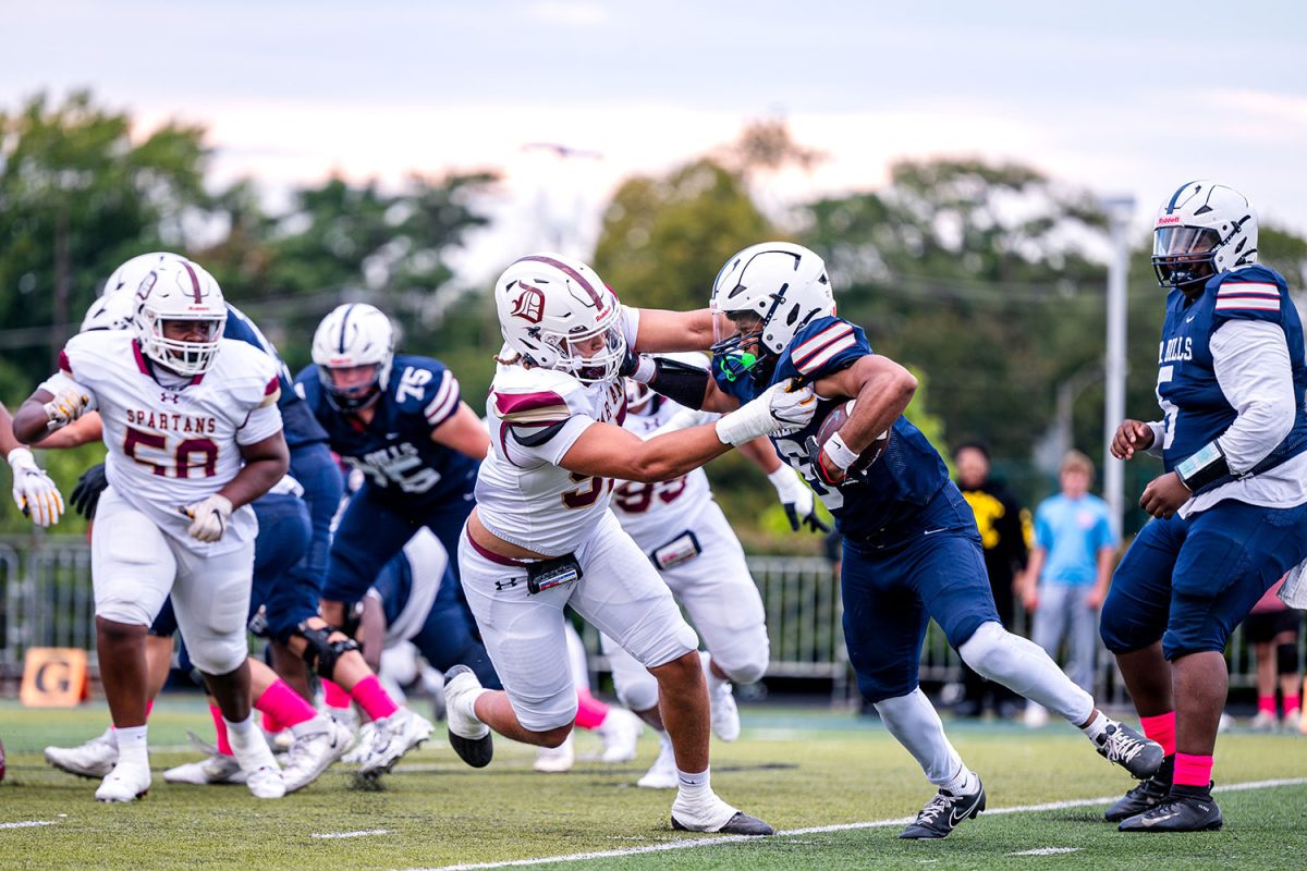 Titan Davis '26 tackles SLUH running back in the 2nd quarter on September 13th 2024 at SLUH.