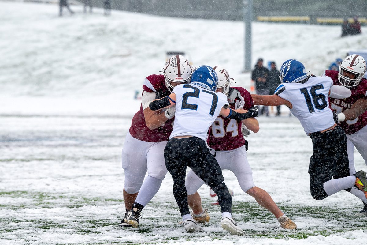 Sam Robinson '25 and Luke Markway '26 tackle a Liberty High School player on Saturday November 30, 2024.