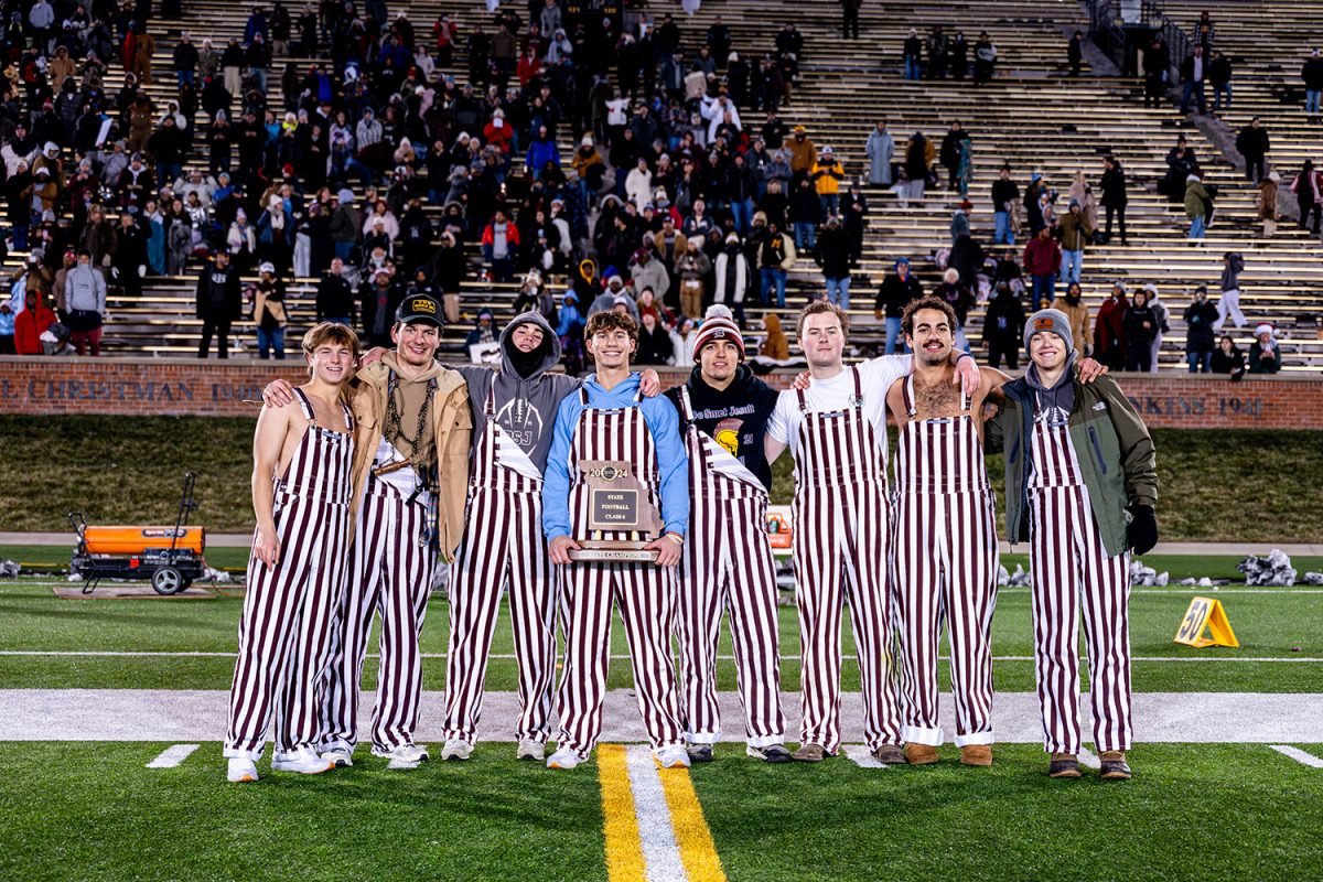 Sports and Spirit pose with the class 6 state championship trophy after the Football Spartans win against Nixa on Friday December 6, 2024 at Mizzou. 