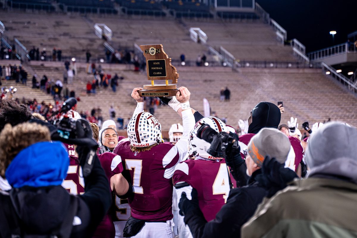 Dillon Duff '25 holds the class 6 state championship trophy after the win against Nixa on Friday December 6, 2024 at Mizzou. 