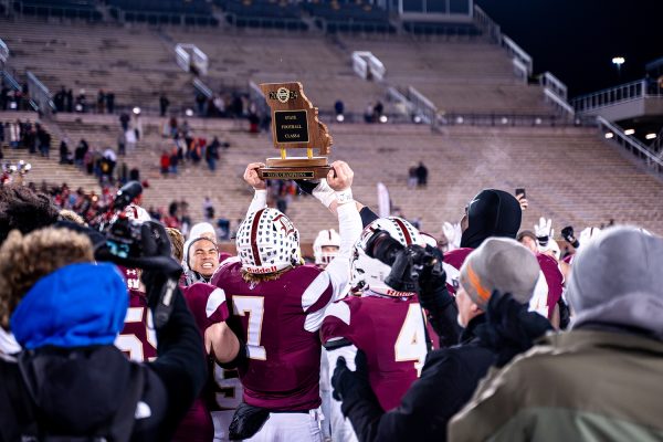 Dillon Duff '25 holds the class 6 state championship trophy after the win against Nixa on Friday December 6, 2024 at Mizzou. 