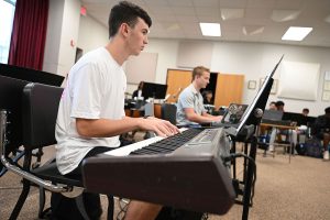 Austin Spinner plays the piano during Honors Jazz Band class. 