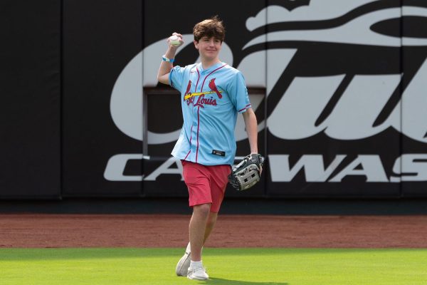 Patrick Dolan '26 playing catch in the busch stadium outfield.   