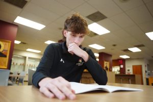 Hayden Schmidt '25 looks at the upcoming class selection curriculum guide. 